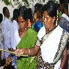 Women with locking at the mouth giving their offerings