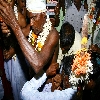 Needle piercing the skin at the waist of the priest during the festival