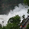 Visitors watching the water flow from dam