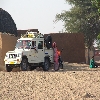 A vehicle in a village inside desert. Taking villages to Jaisalmer 