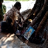 girl performing Sai Ram pooja near tree