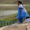 Girl looking at a pond curiously