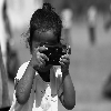 Small kid taking photo using P & S film camera