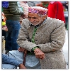 old man looking curiously at a conversation, streets of Manali