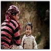 Boy along with mother looking smilingly