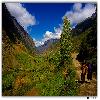 Local people walking along the road towards Trilokinath