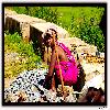 a lady sitting and breaking the pebbles for her daily earnings