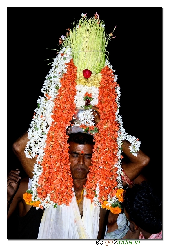 Priest holding the Kalasham on his head