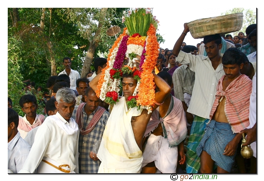 Priest holding the Kalasham on his head