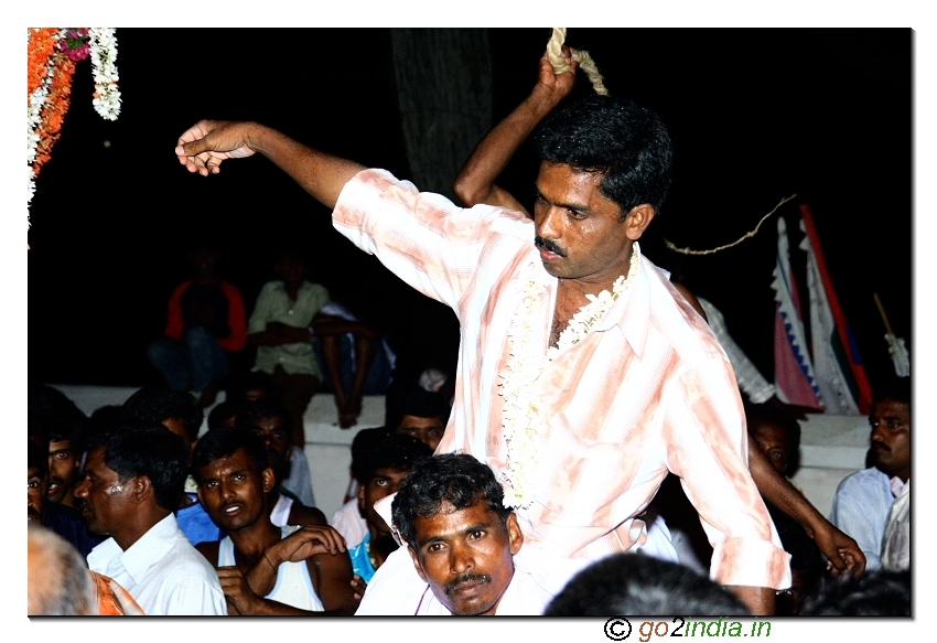 Hitting the hands of a person with rope during the festival