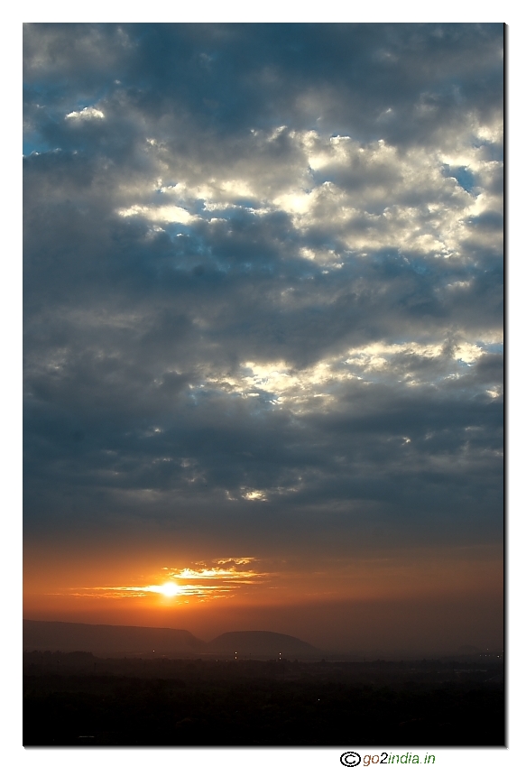 Sun set with glow formation in the clouds with peeping rays