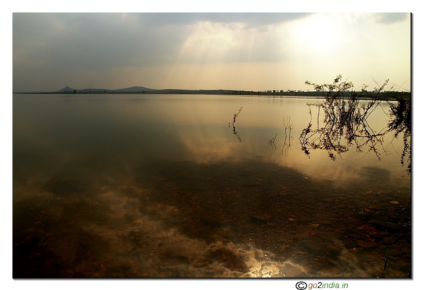 Sun reflection at water with globe rays formation