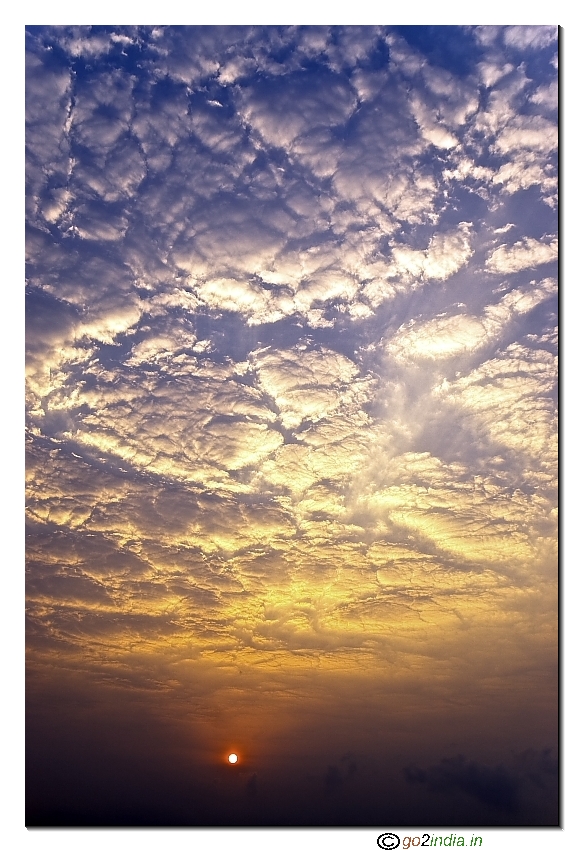 Sun rise with scattering clouds at golden early morning lighting