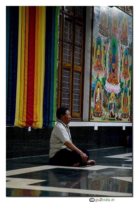 A person meditating inside a buddhist monestary