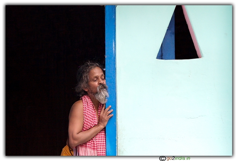 candid of a person standing near the door and observing people moving around