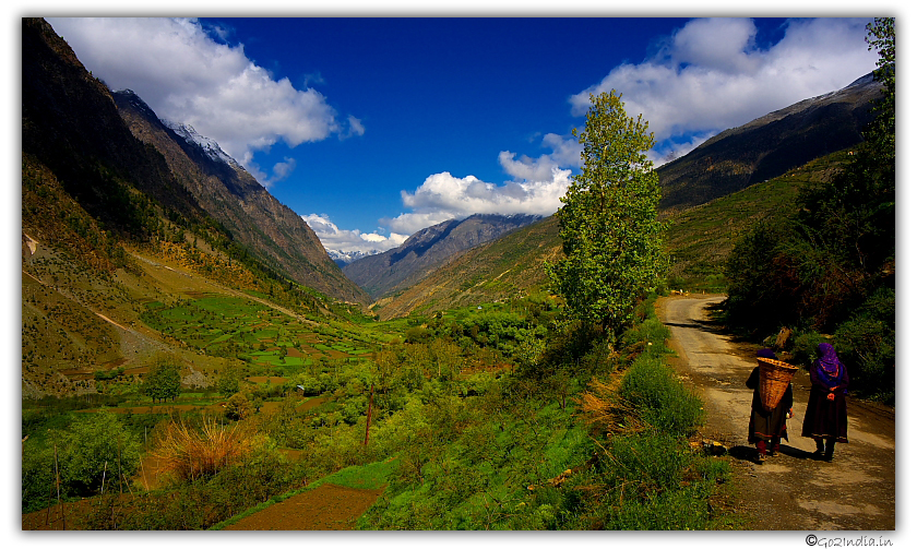 Local people walking along the road towards Trilokinath