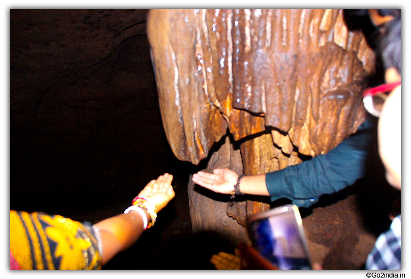 Water drops falling from stalactites inside cave of Gupteswar